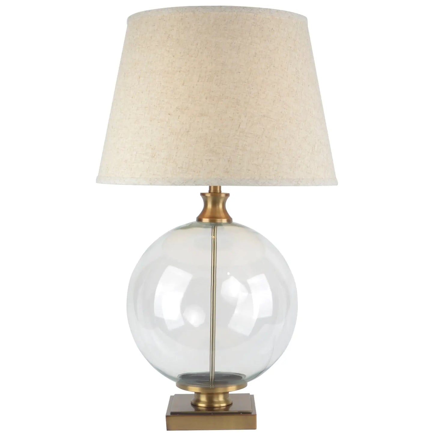 Table lamp with clear glass base, gold accents, and beige fabric shade on a white background