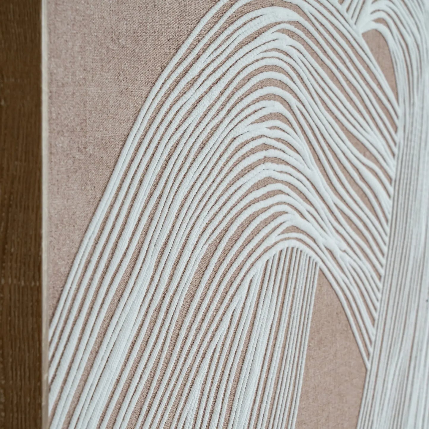 Close-up of a textured surface with wavy line pattern on a beige background