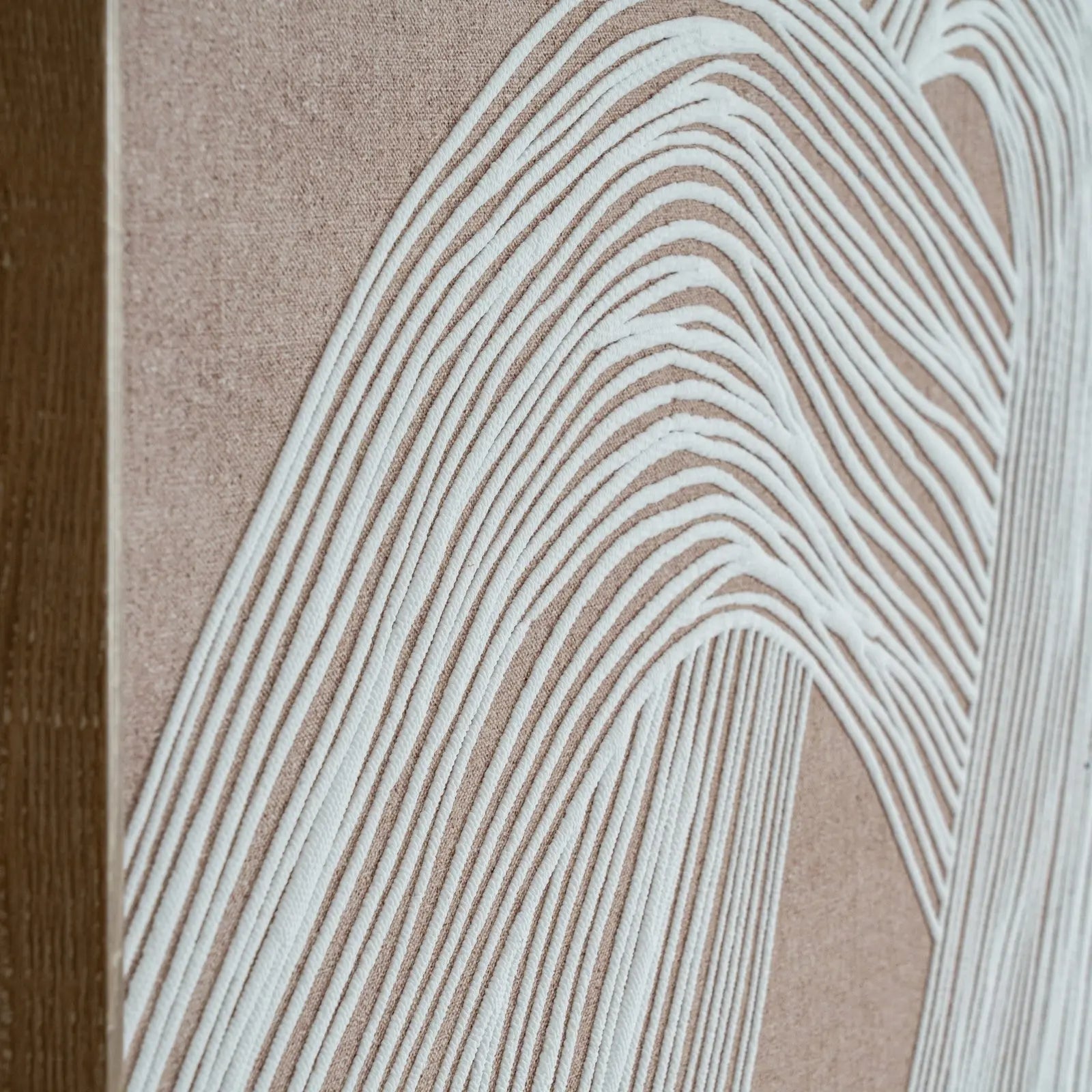 Close-up of a textured surface with wavy line pattern on a beige background