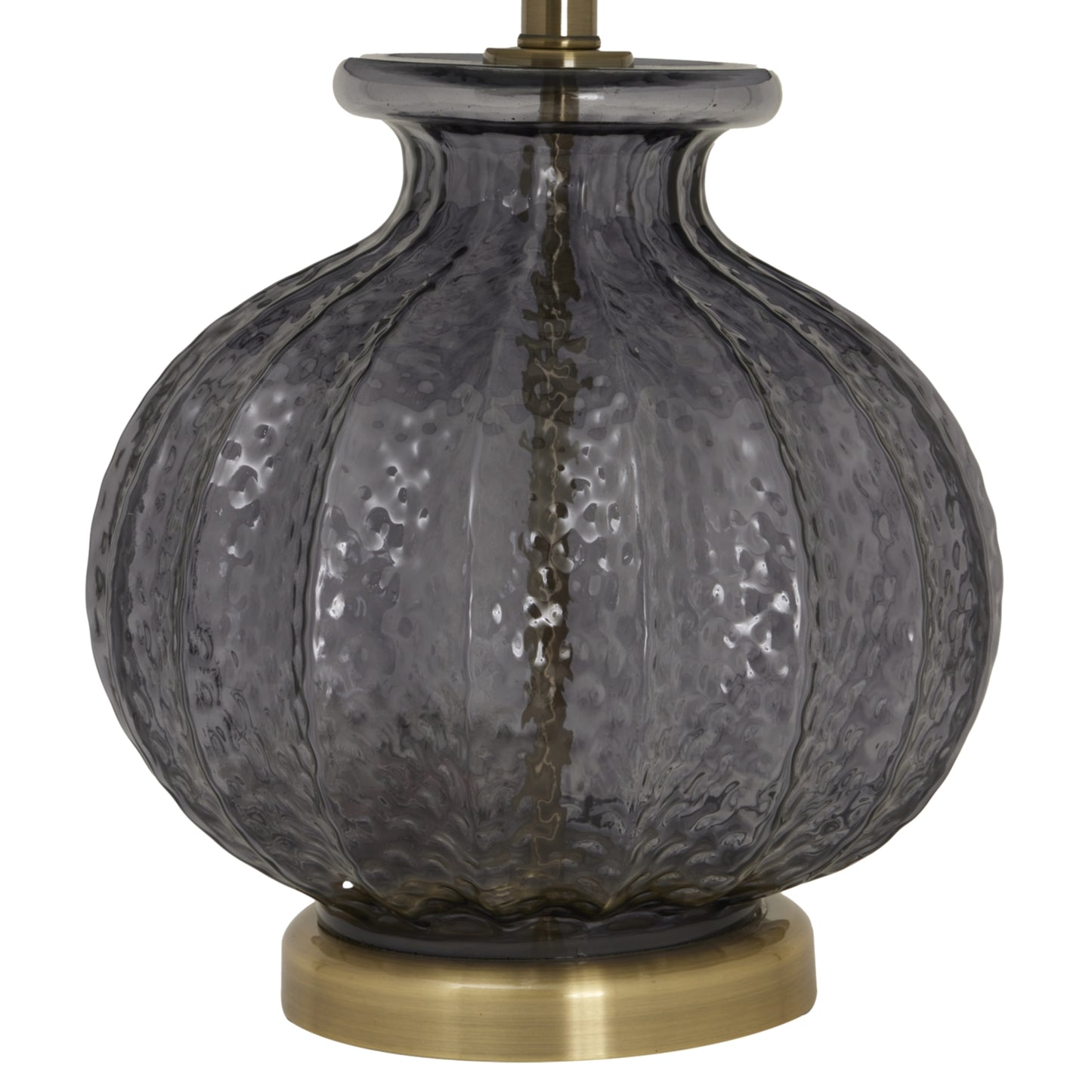 Decorative lamp with textured glass shade and brass base on a white background