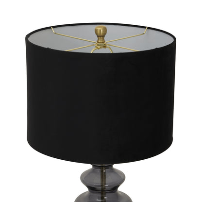Black lamp with a gold fixture on a white background