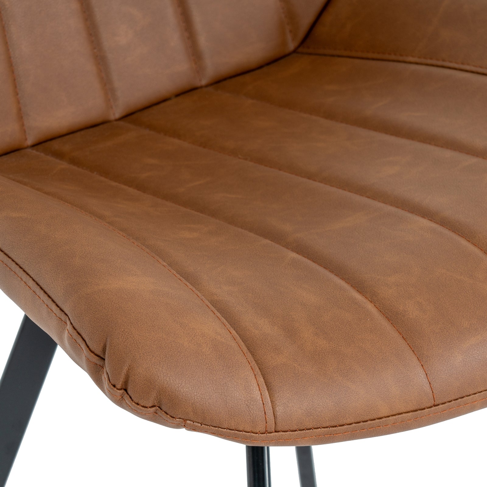 Close-up of a brown leather chair seat with visible wear.