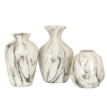 Three marble-patterned vases of different sizes on a white background