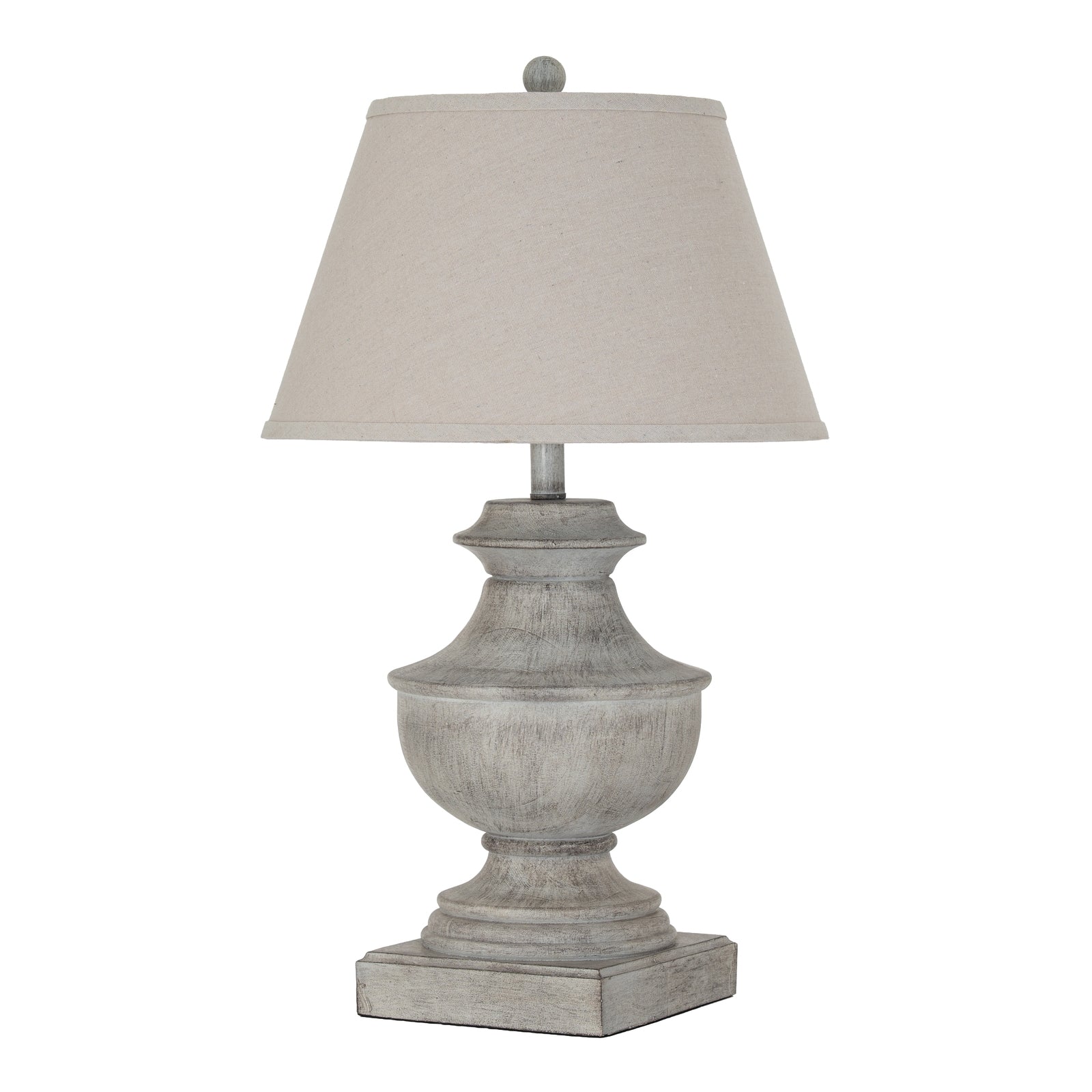 Table lamp with a textured base and beige shade on a white background