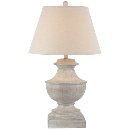 Table lamp with a beige shade and textured base on a white background