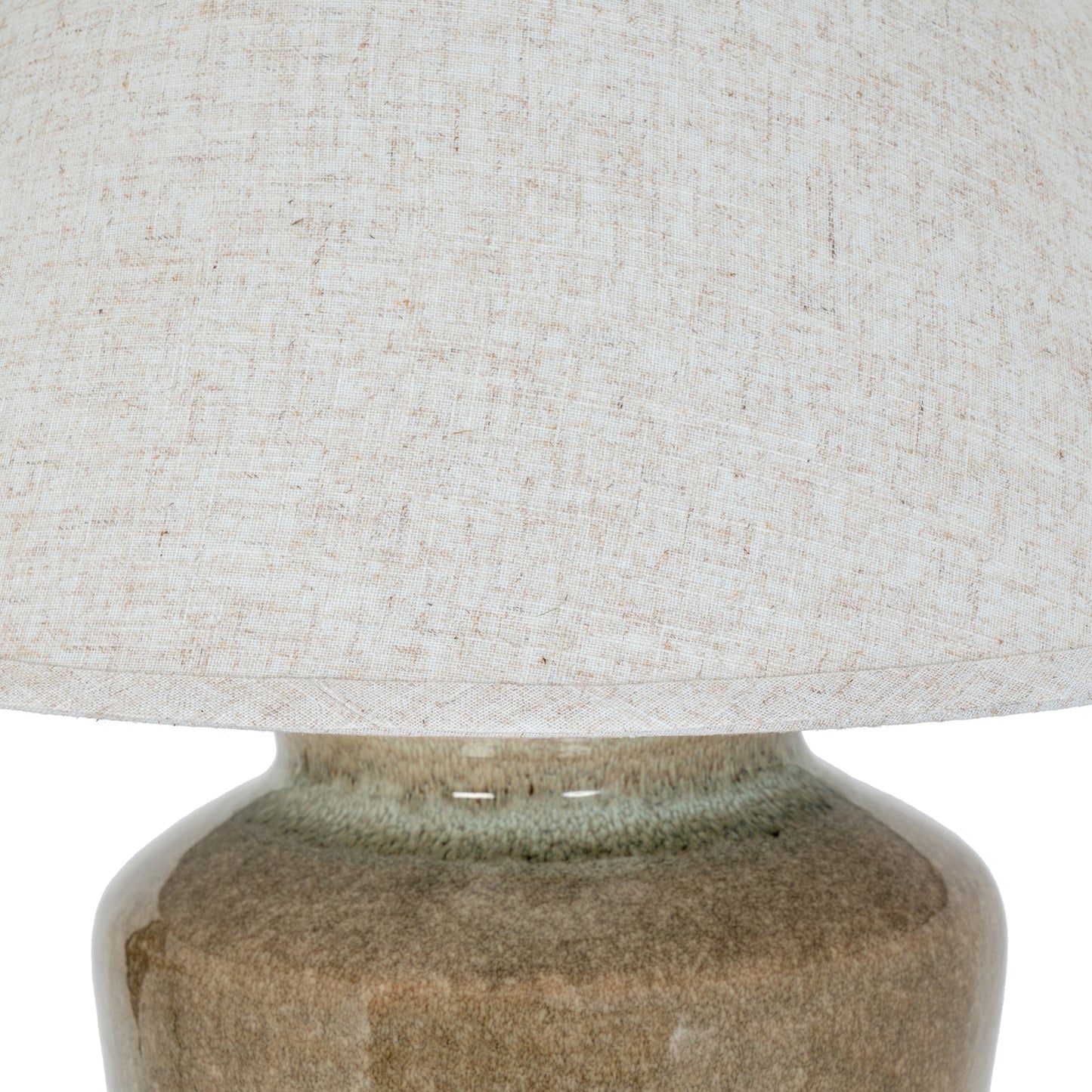 Close-up of a textured lampshade on a ceramic base
