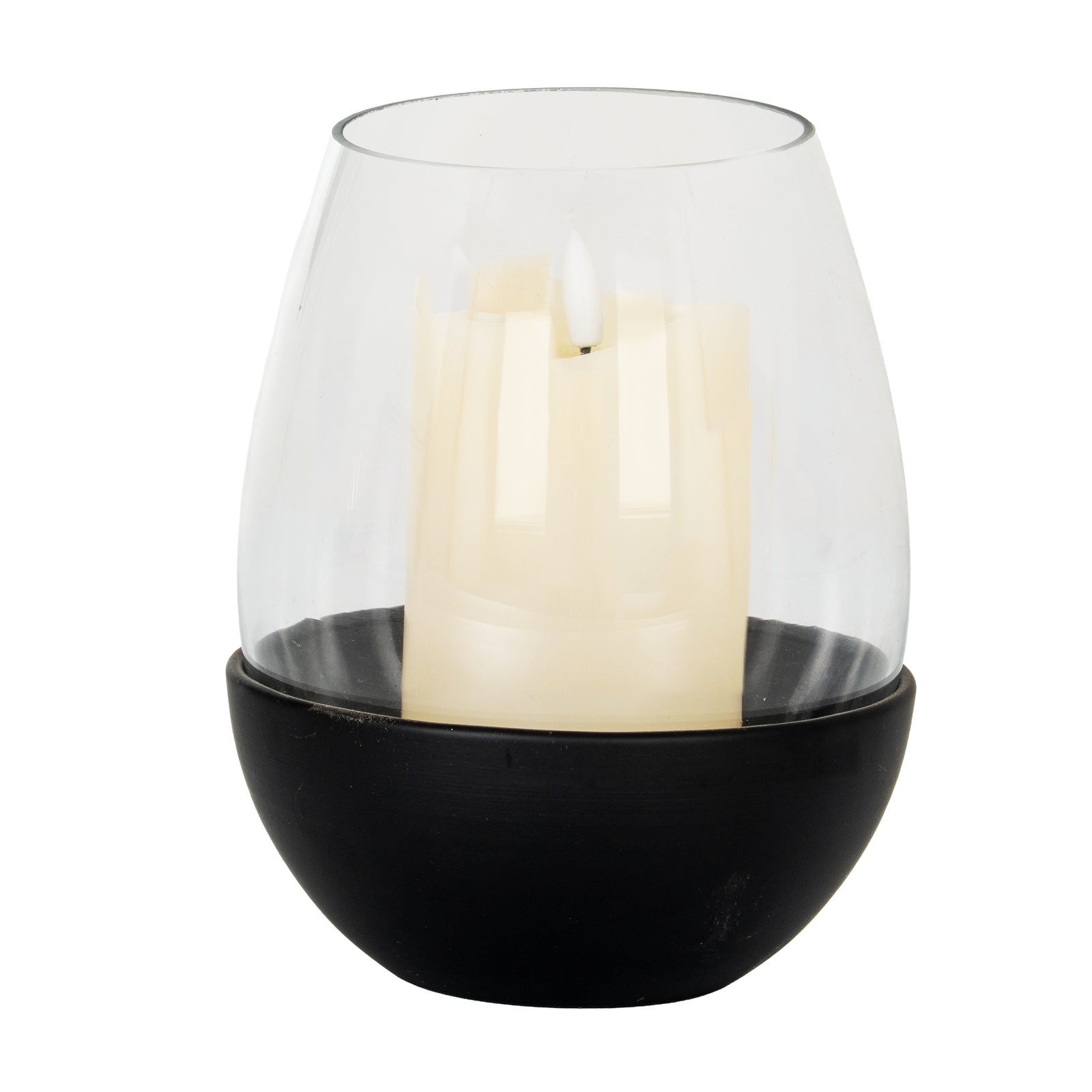 Clear glass candle holder with a black base containing a white candle on a white background