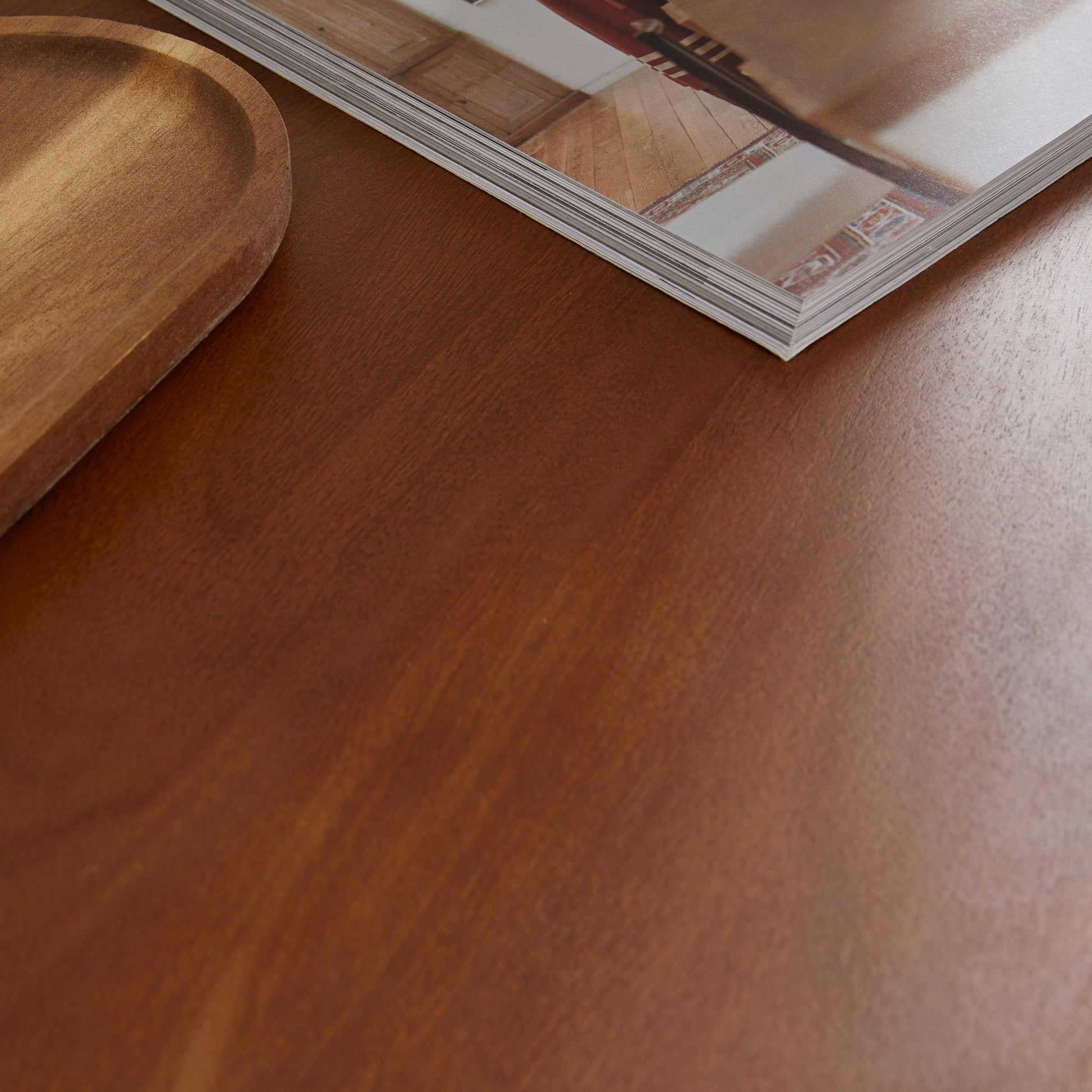 Wooden surface with a magazine and wooden tray