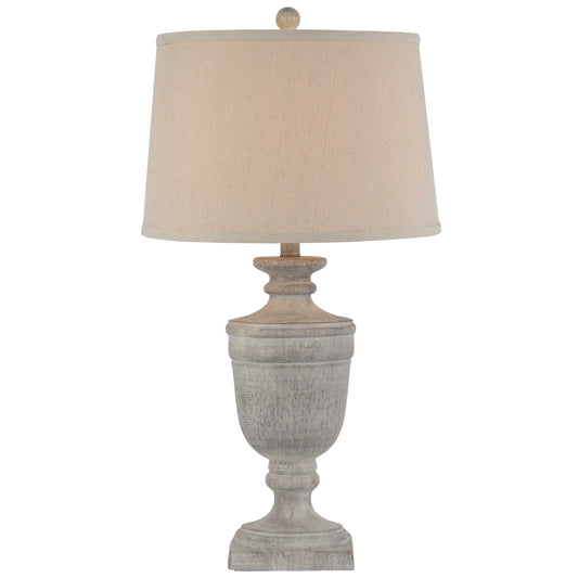 Table lamp with a textured base and beige lampshade on a white background