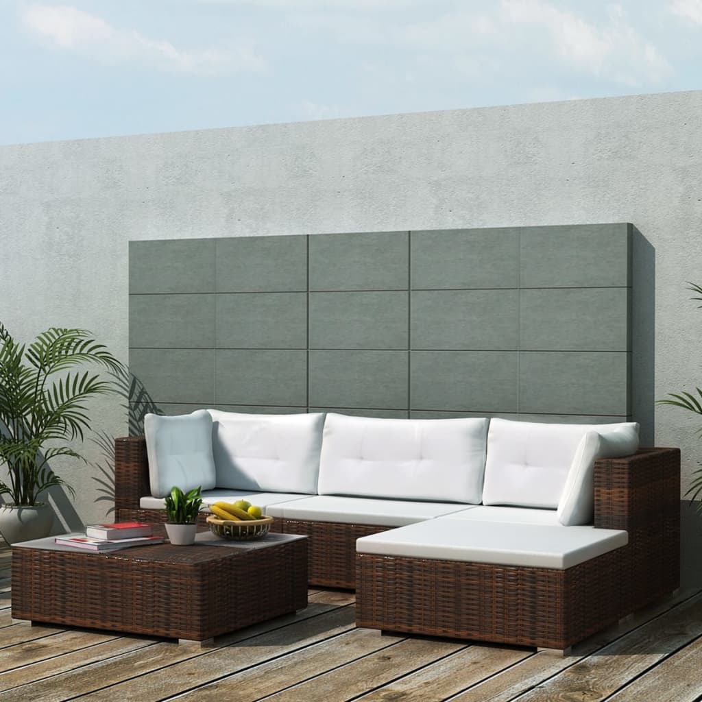 Outdoor patio furniture set with a sectional sofa and coffee table on a wooden deck.