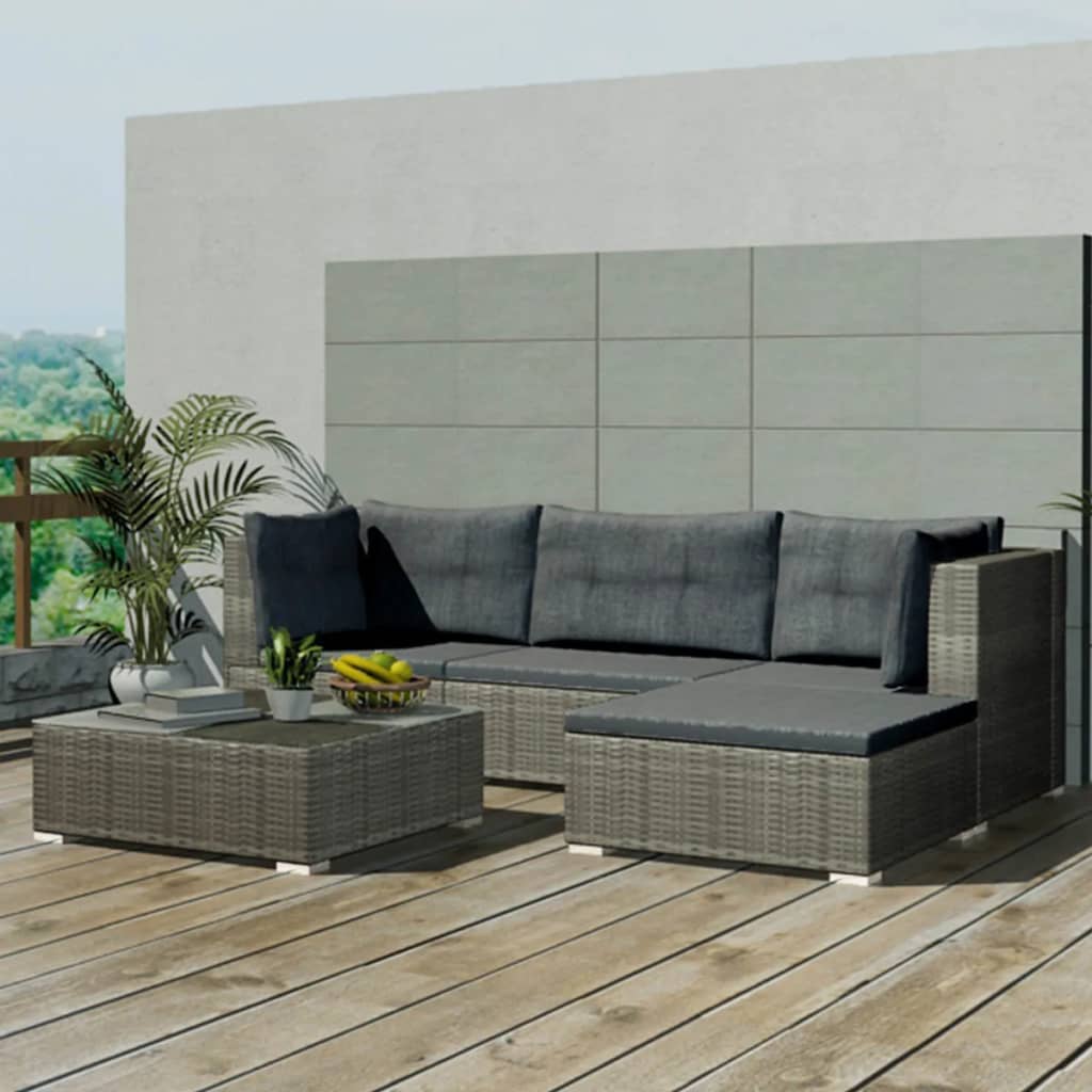 Outdoor patio furniture set with a sectional sofa and coffee table on a wooden deck.