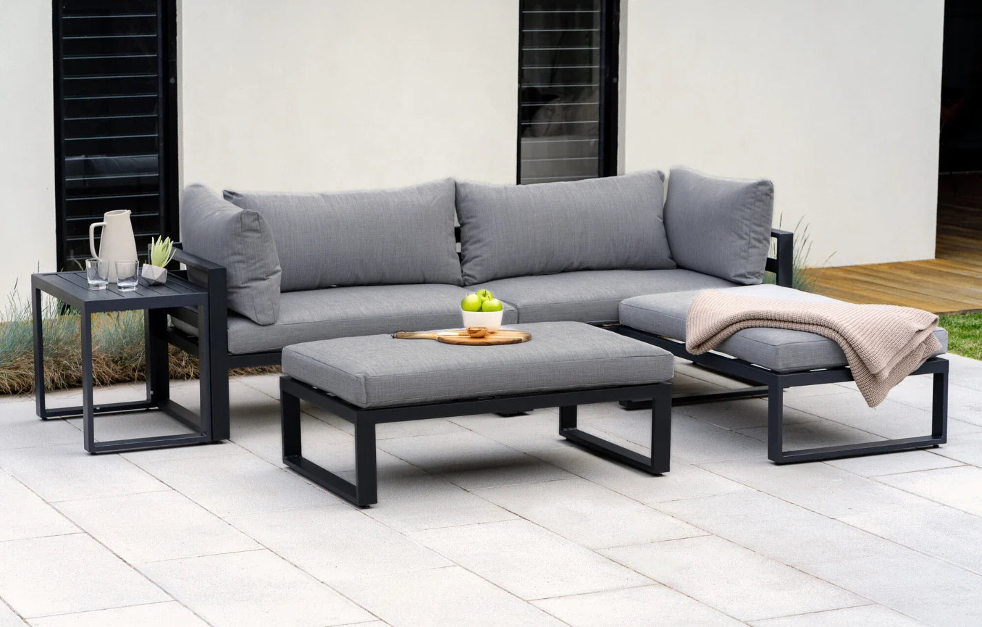 Outdoor patio set with gray cushions on a patio