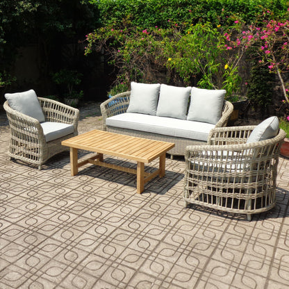 Outdoor patio set with wicker chairs, sofa, and table on a patterned patio.