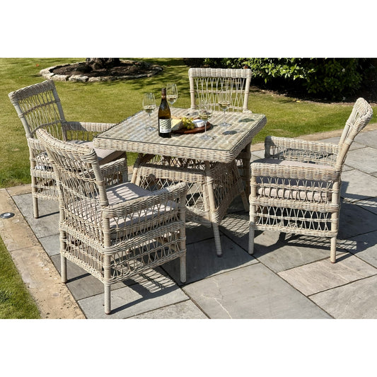 Wicker outdoor dining set with table and chairs on a patio