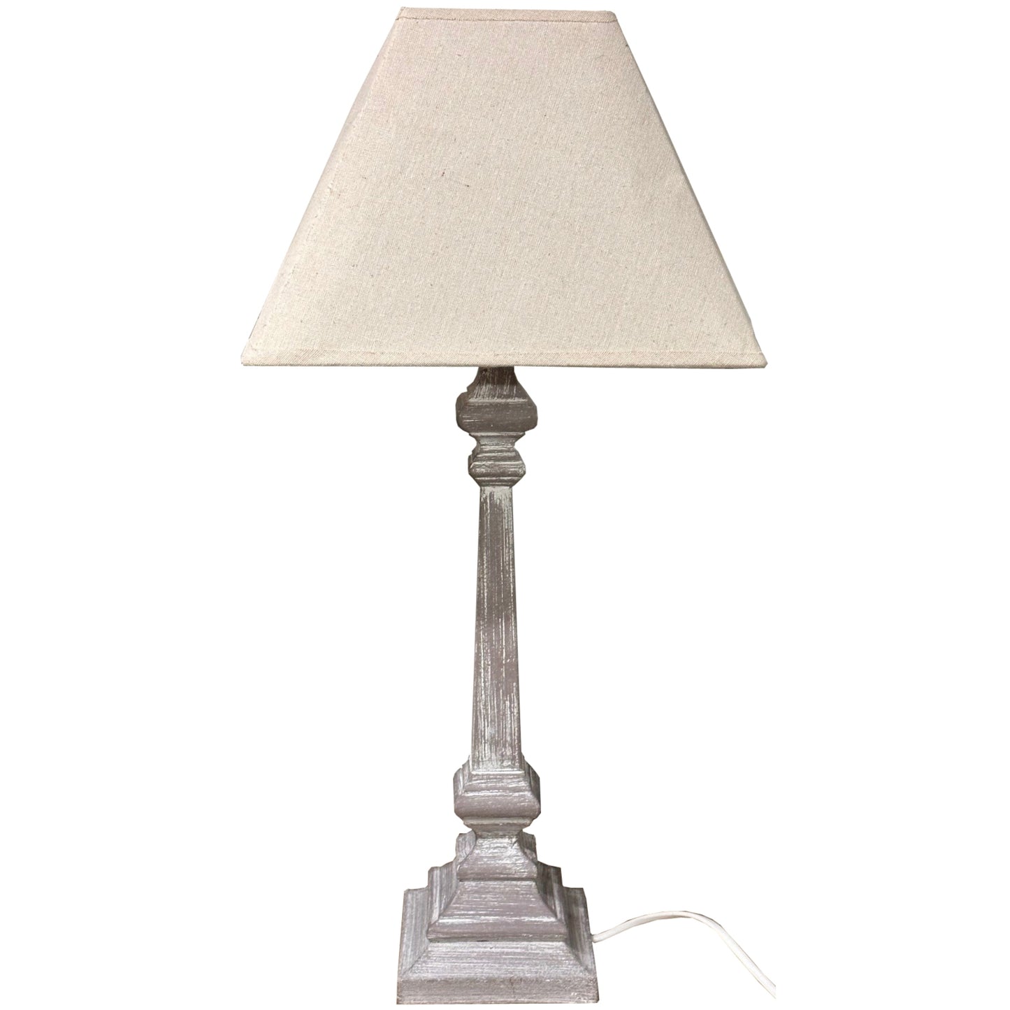 Table lamp with beige shade and wooden base on a white background