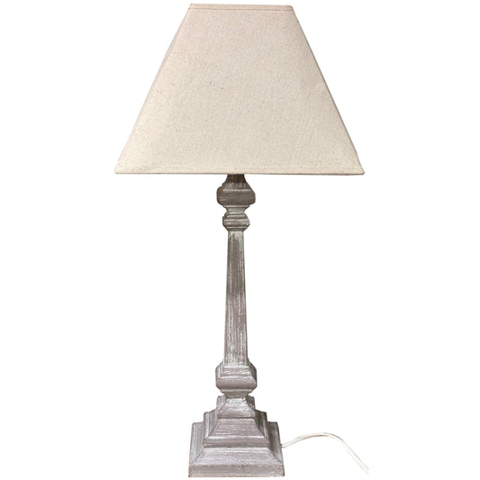 Table lamp with beige shade and wooden base on a white background