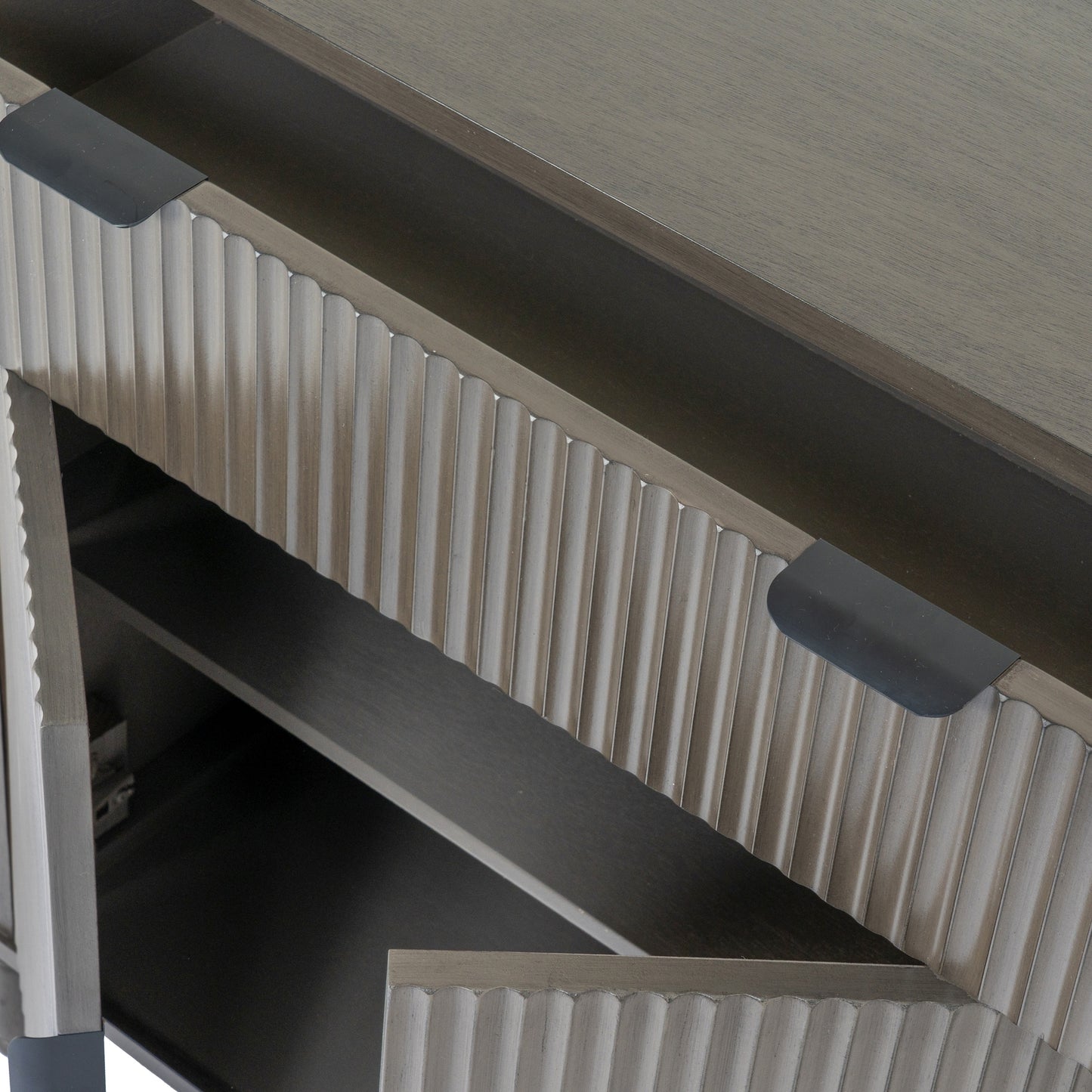 Close-up of a metallic surface with ribbed design and two light fixtures.