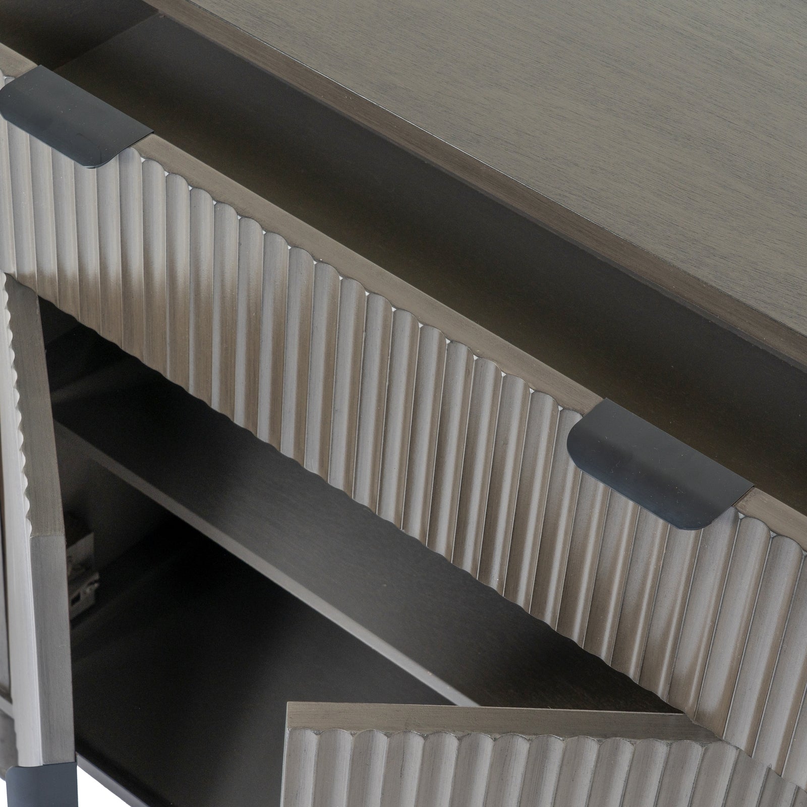 Close-up of a metallic surface with ribbed design and two light fixtures.