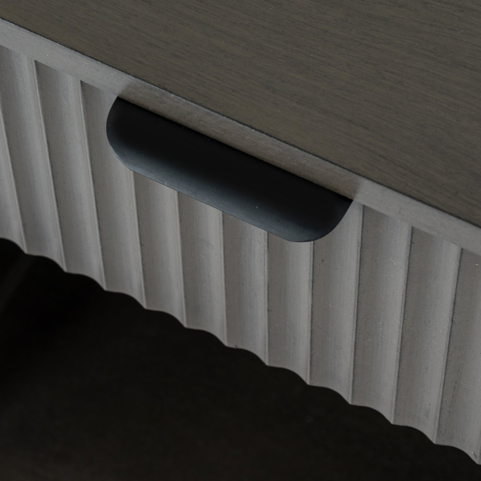 Close-up of a textured surface with a handle and ribbed pattern.