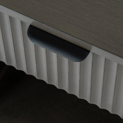 Close-up of a textured surface with a handle and ribbed pattern.