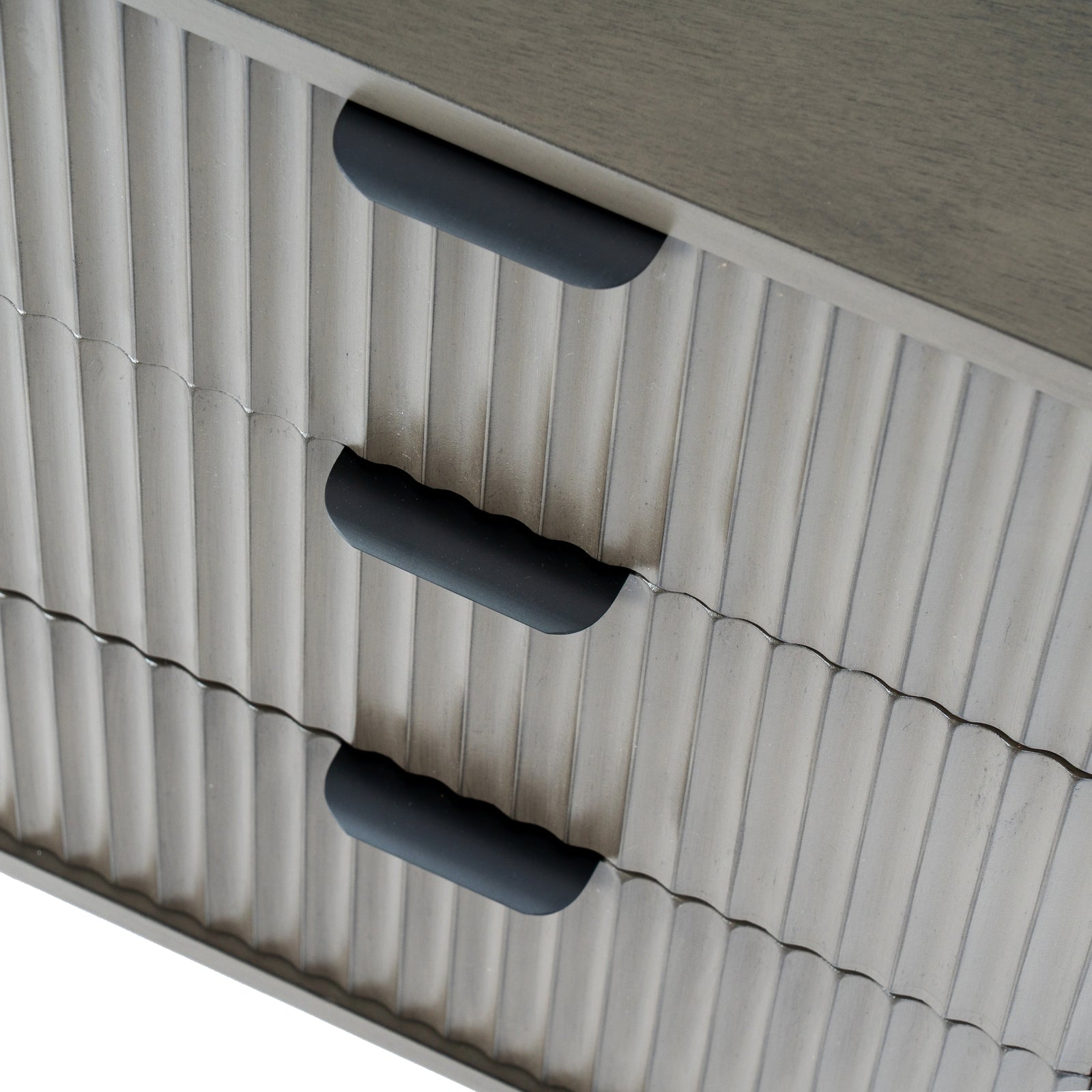 Close-up of a textured surface with three black handles