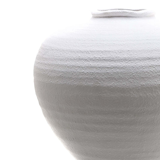 Close-up of a textured white vase on a white background