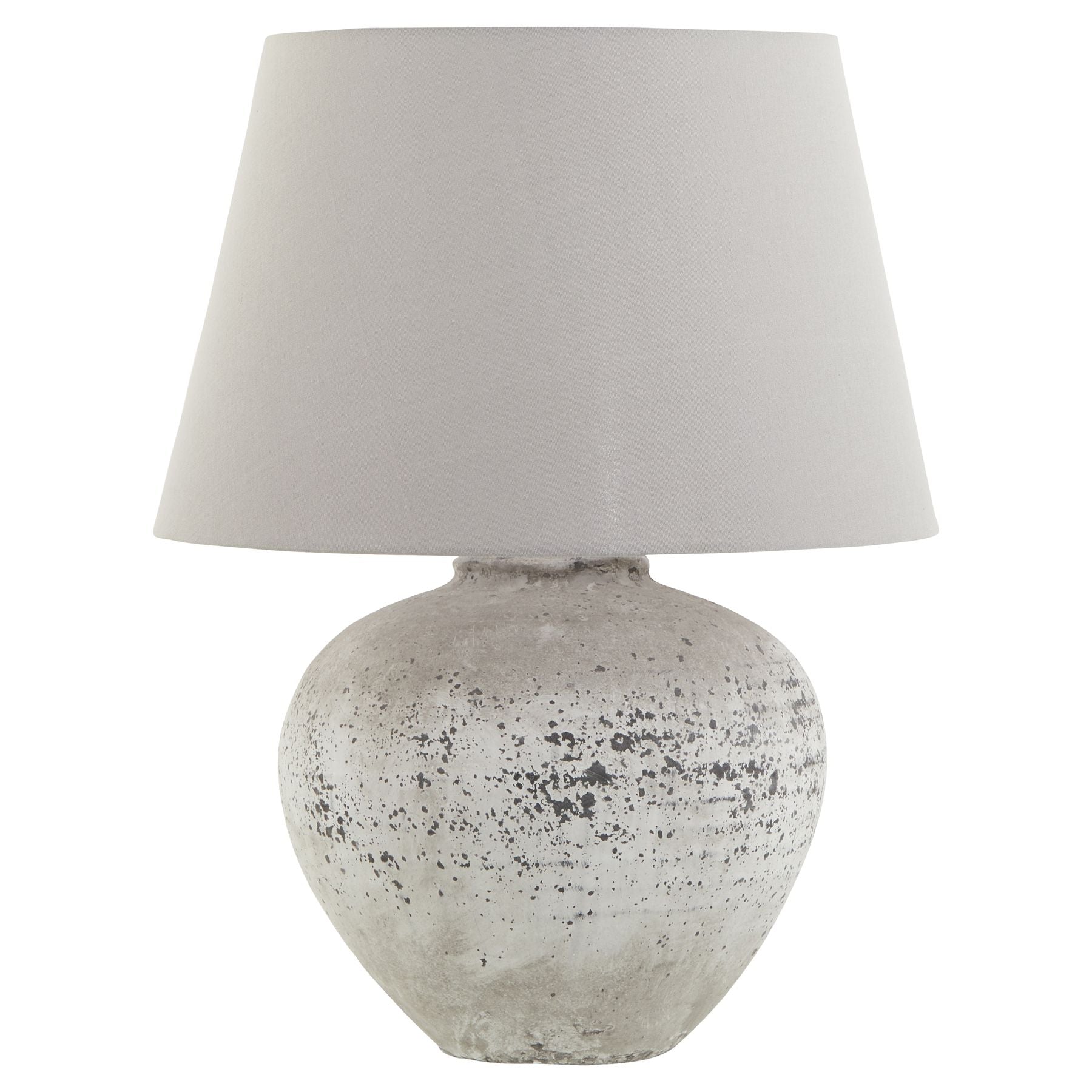Table lamp with textured gray base and white shade on a white background