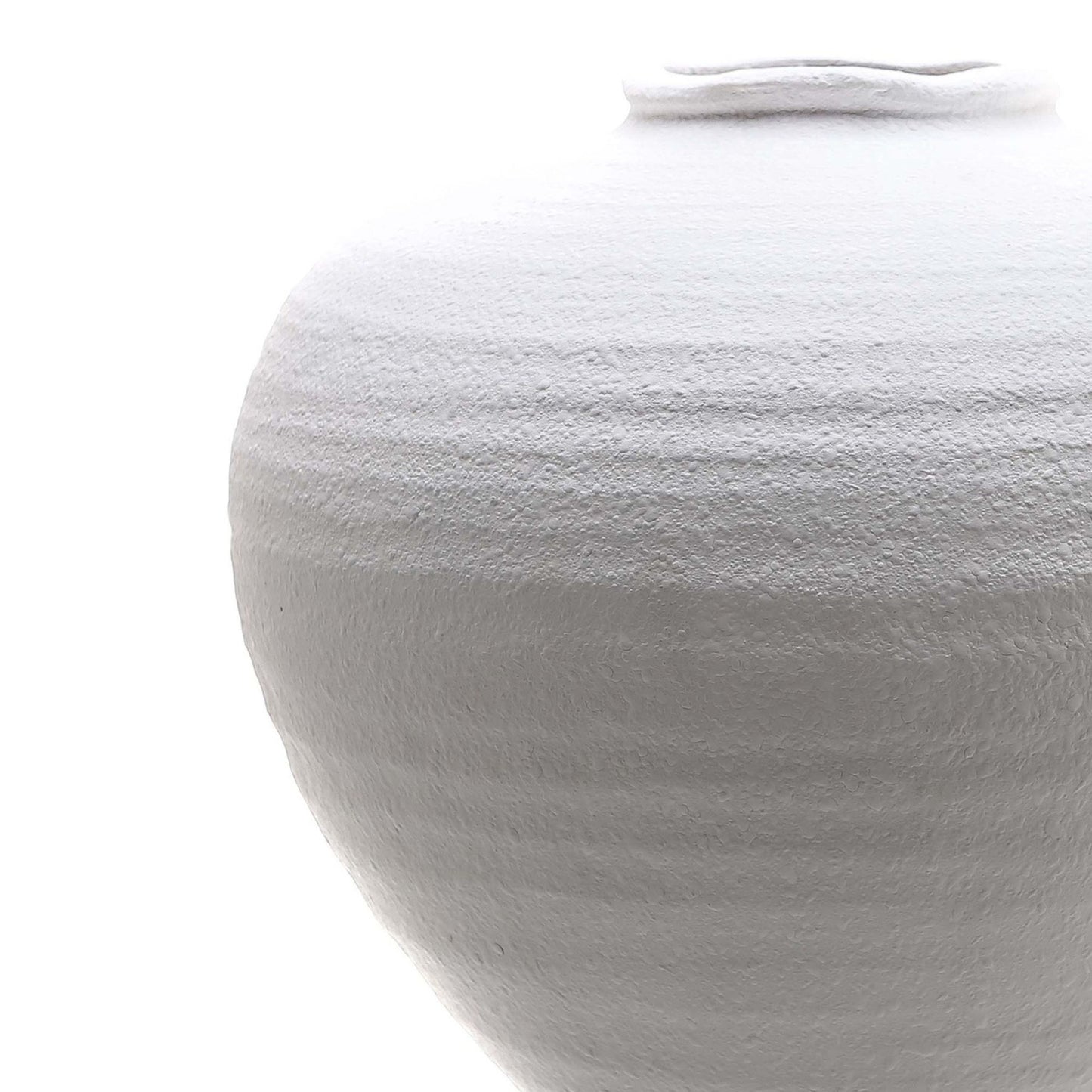 Close-up of a textured white vase on a white background