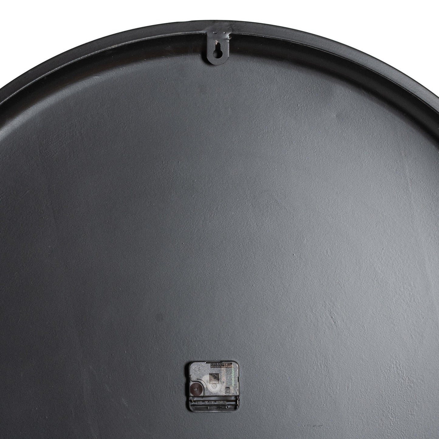 Close-up of a black metal lid with a small square handle on a white background