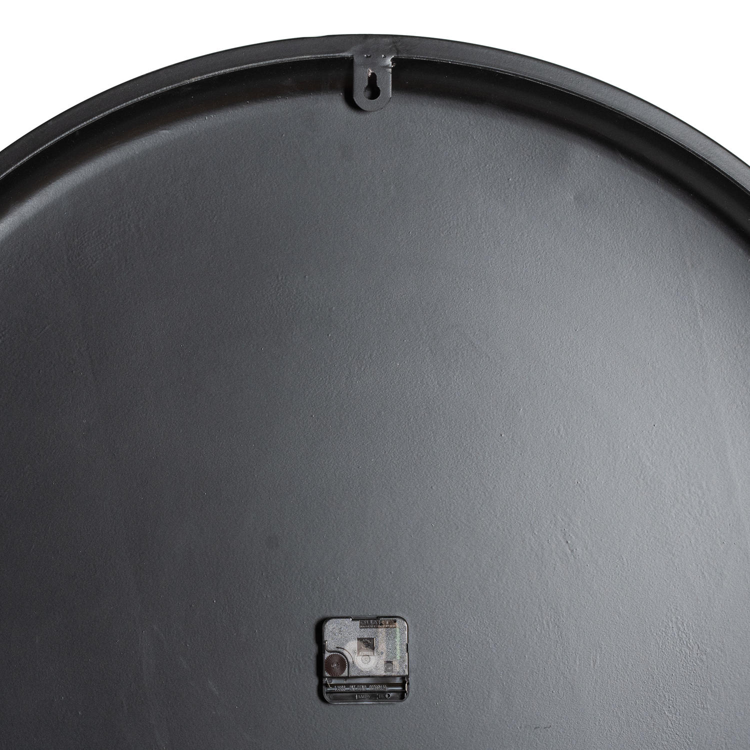 Close-up of a black metal lid with a small square handle on a white background