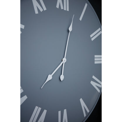 Close-up of a clock face with Roman numerals on a dark background