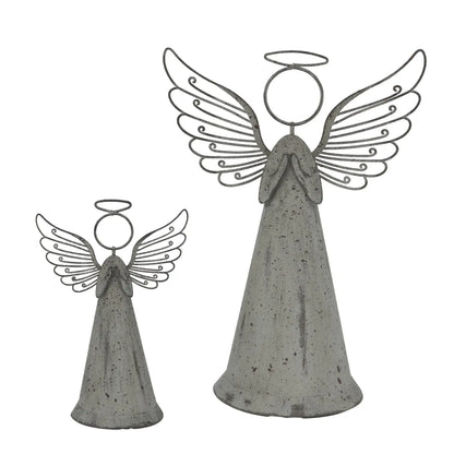 Two concrete angel statues with wings and halos on a white background