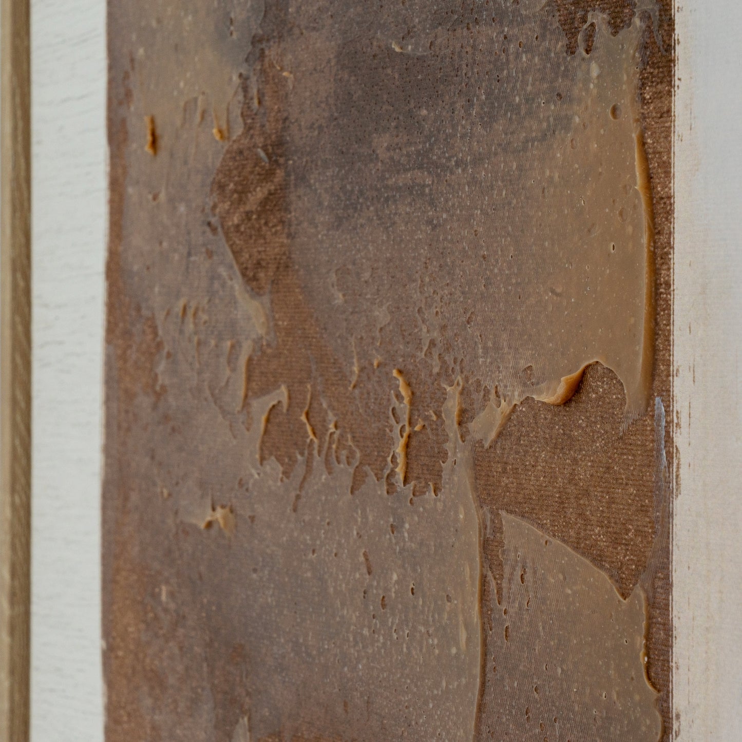 Close-up of a textured brown surface with visible wear and tear