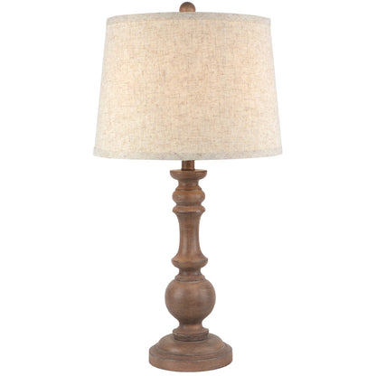 Table lamp with wooden base and beige fabric shade on a white background