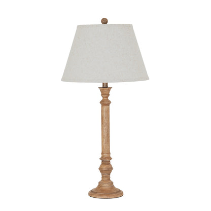 Table lamp with wooden base and white shade on a white background