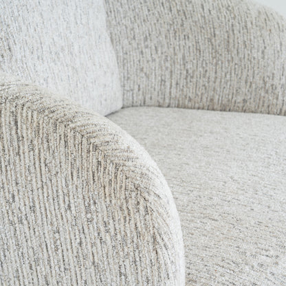 Close-up of a textured gray sofa with a focus on the fabric pattern.