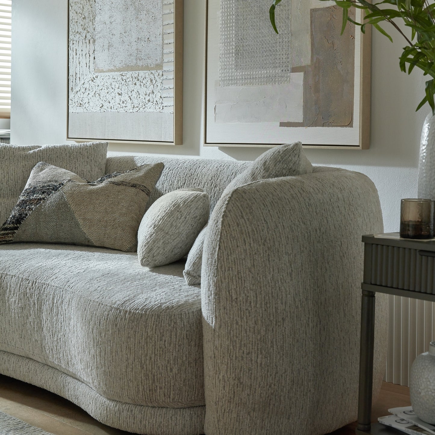 Gray sofa with decorative pillows in a living room setting