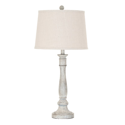 Table lamp with a white shade and wooden base on a white background
