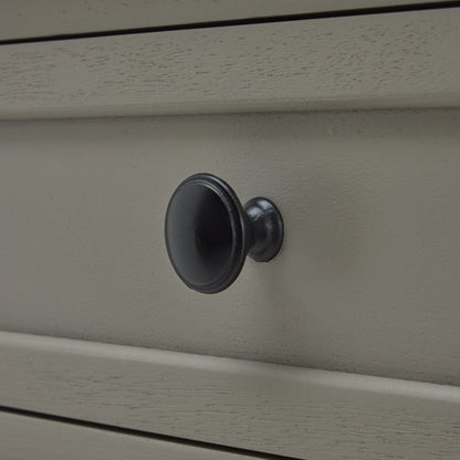 Close-up of a gray cabinet with a black knob