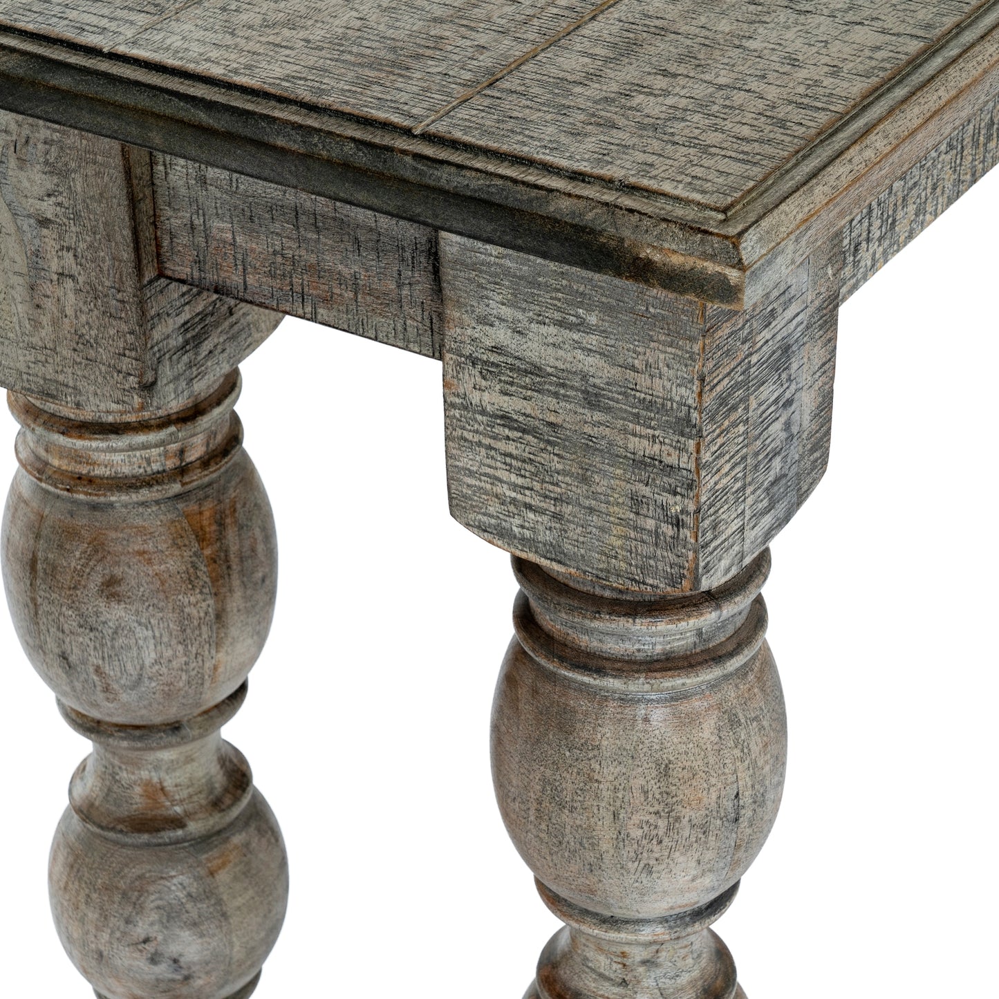 Close-up of a wooden table with turned legs on a white background