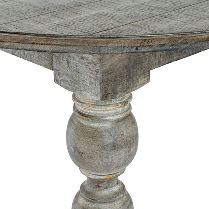 Round wooden table with a textured surface and decorative pedestal base on a white background