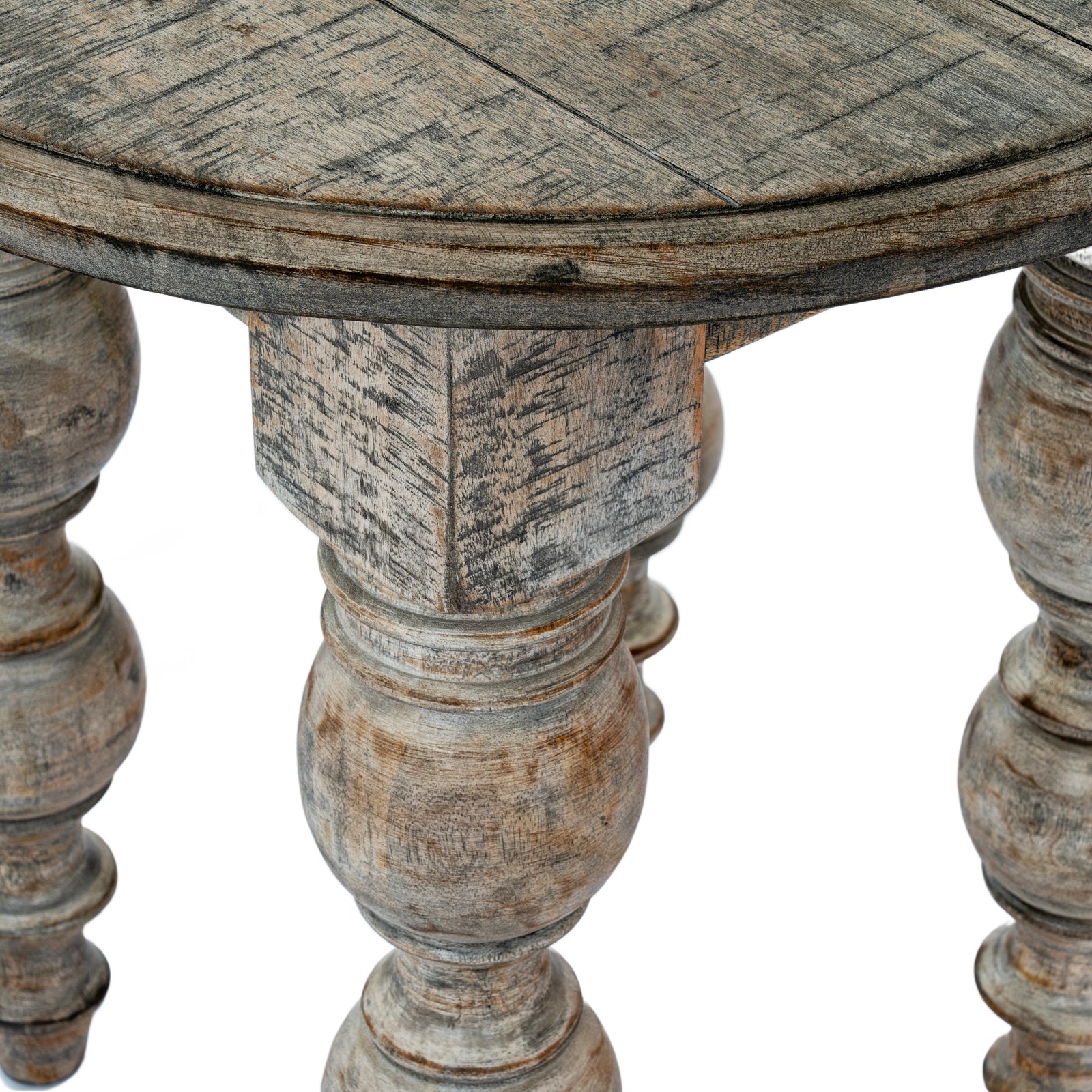 Round wooden table with aged, rustic finish on a white background