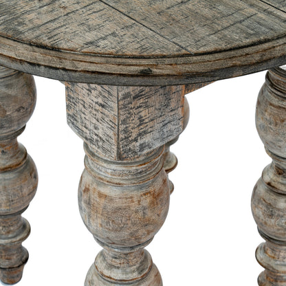 Round wooden table with aged, rustic finish on a white background