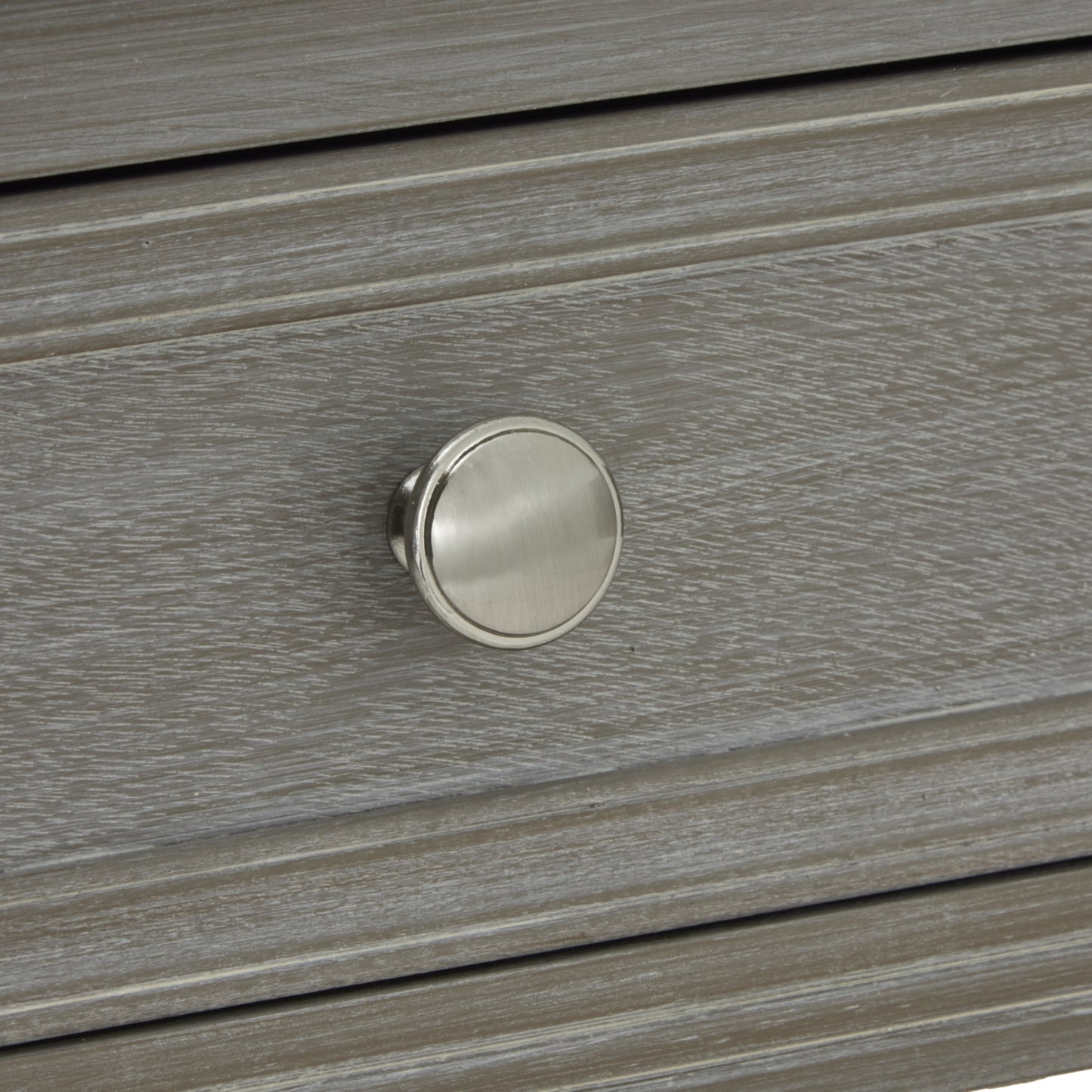 Close-up of a wooden drawer with a metallic knob