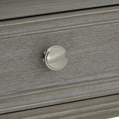 Close-up of a wooden drawer with a metallic knob
