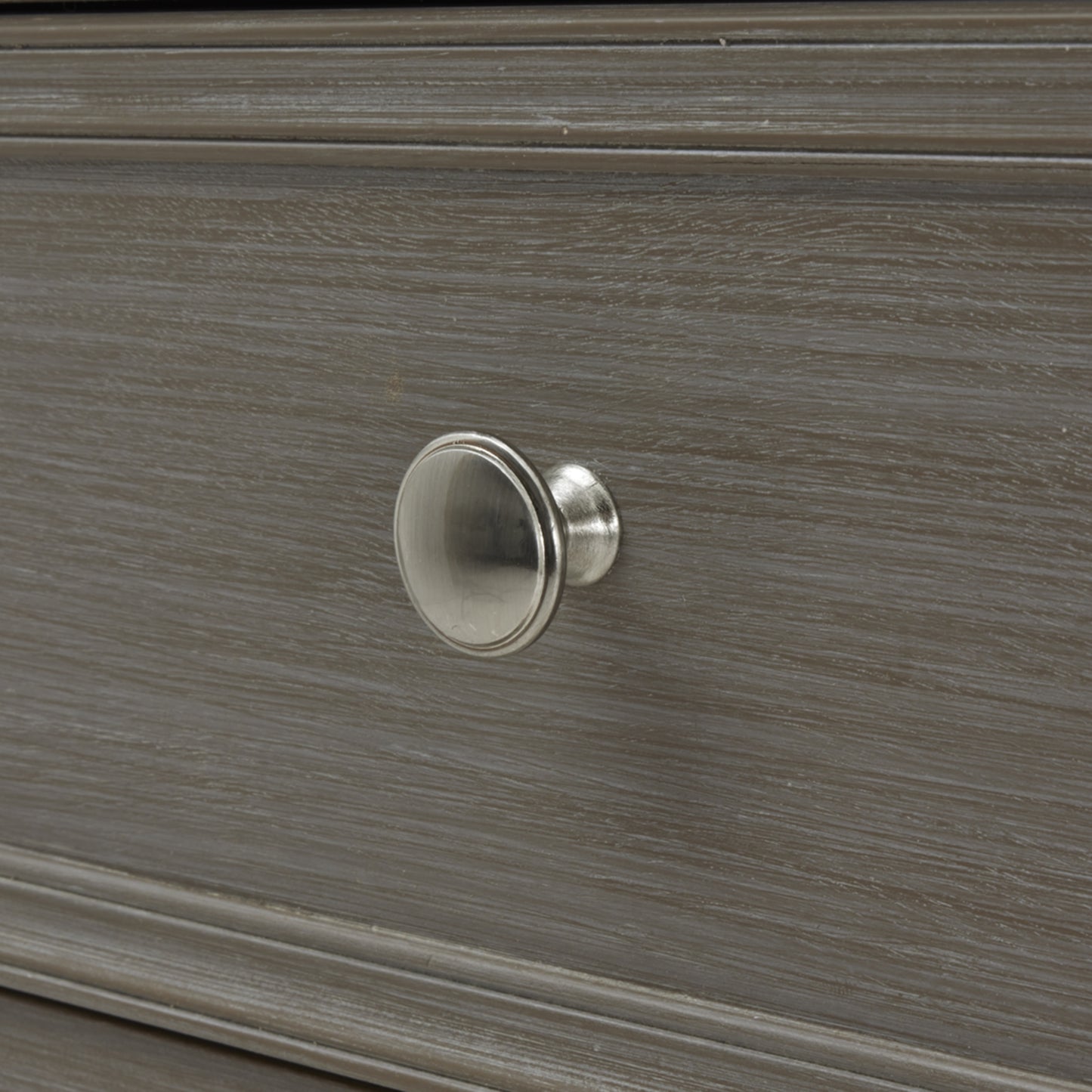 Close-up of a wooden drawer with a metal knob