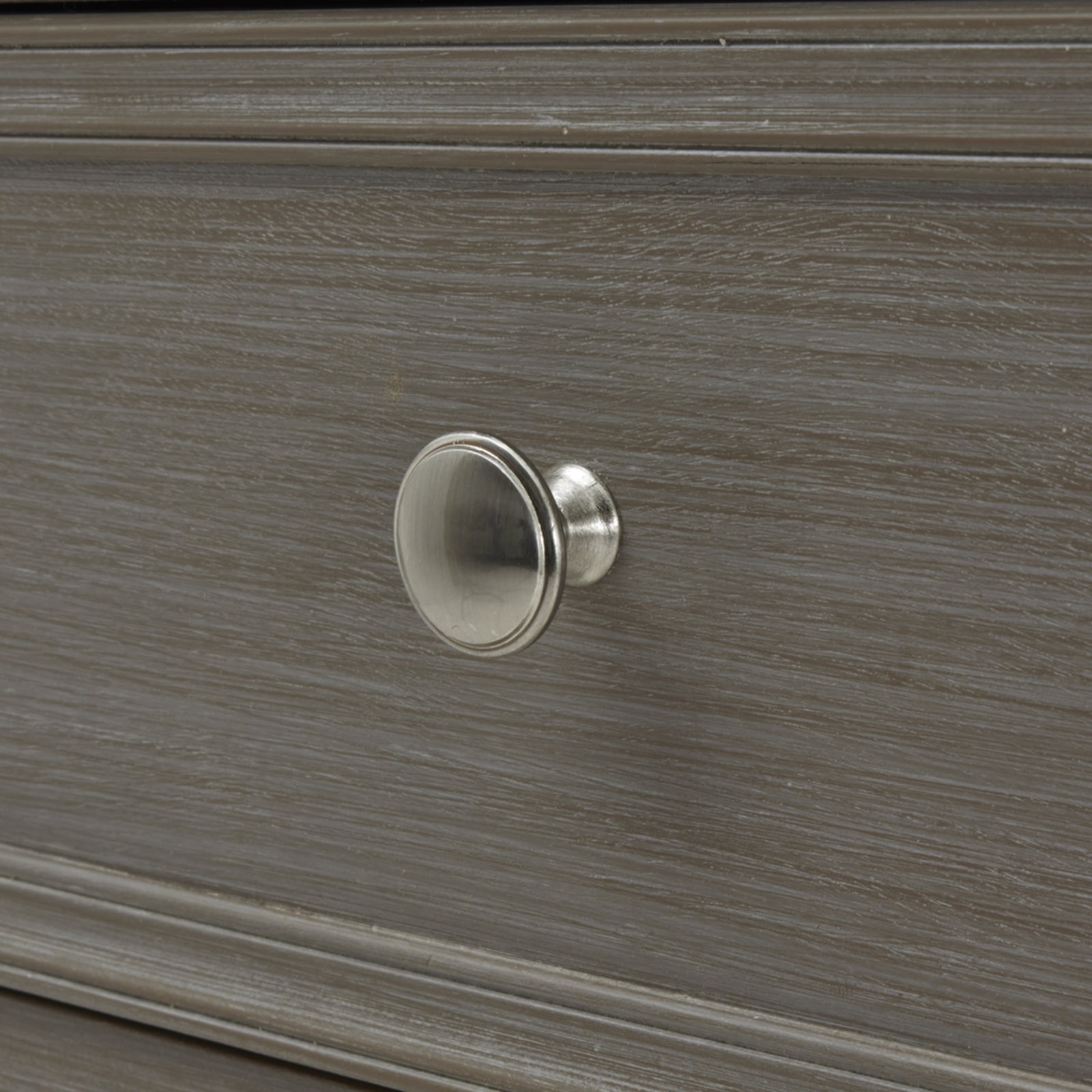 Close-up of a wooden drawer with a metal knob