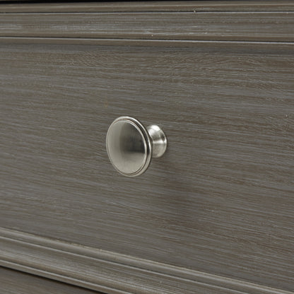 Close-up of a wooden drawer with a metal knob