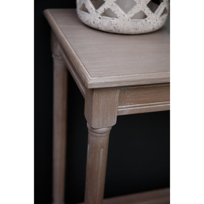 Wooden side table with a decorative item on top against a black background