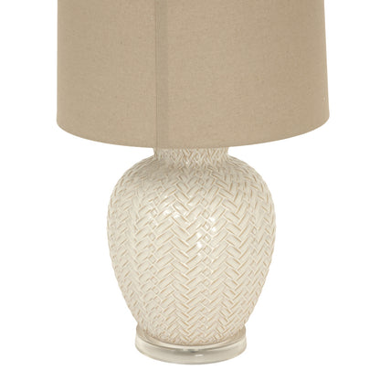Decorative lamp with woven design on a white background